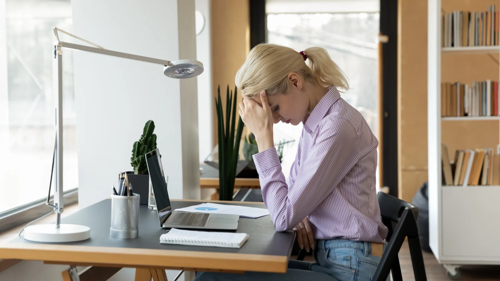 Woman stressed at her desk – online psychiatry in Bakersfield, CA